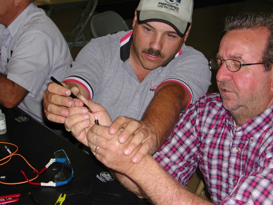 A group of people sitting and looking at the camera

Description automatically generated